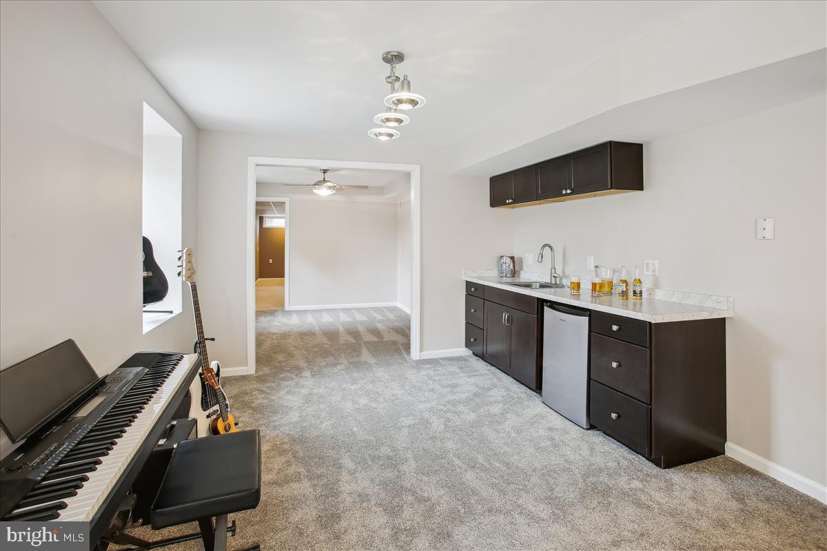 20702 Pomeroy Court Ashburn, VA 20147 - Photo 48 of 60 a living room with furniture and a flat screen tv