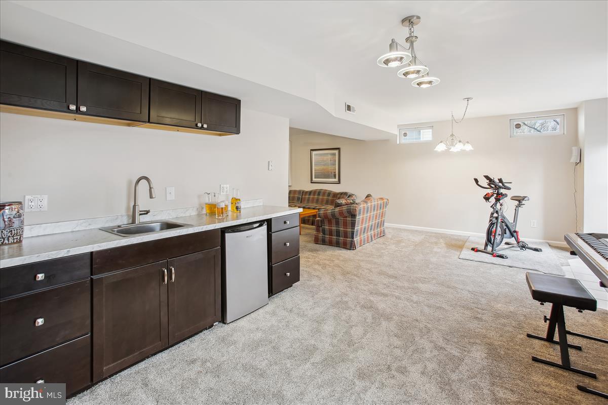 20702 Pomeroy Court Ashburn, VA 20147 - Photo 49 of 60 a kitchen with a sink and cabinets