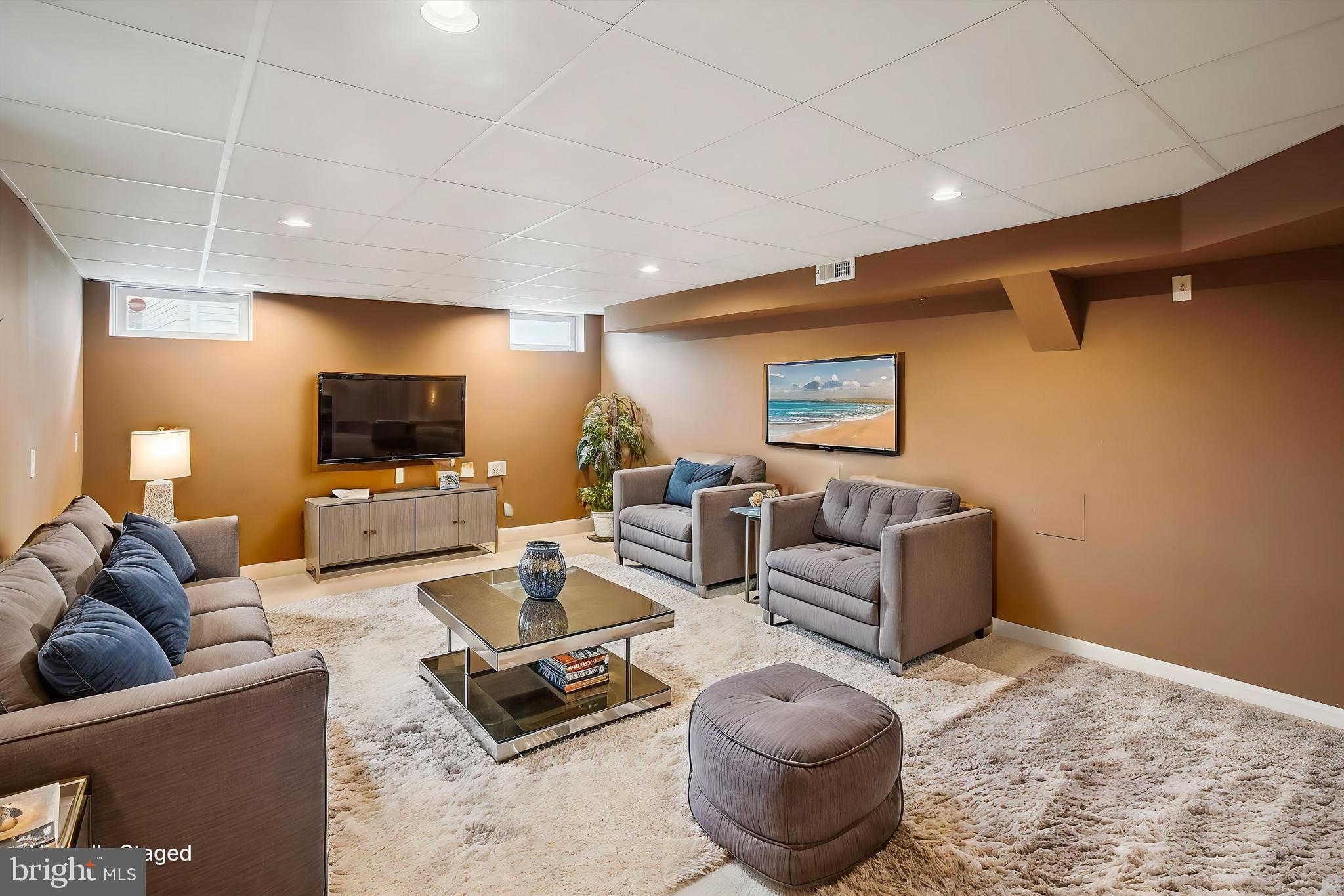 20702 Pomeroy Court Ashburn, VA 20147 - Photo 52 of 60 a living room with furniture and a flat screen tv