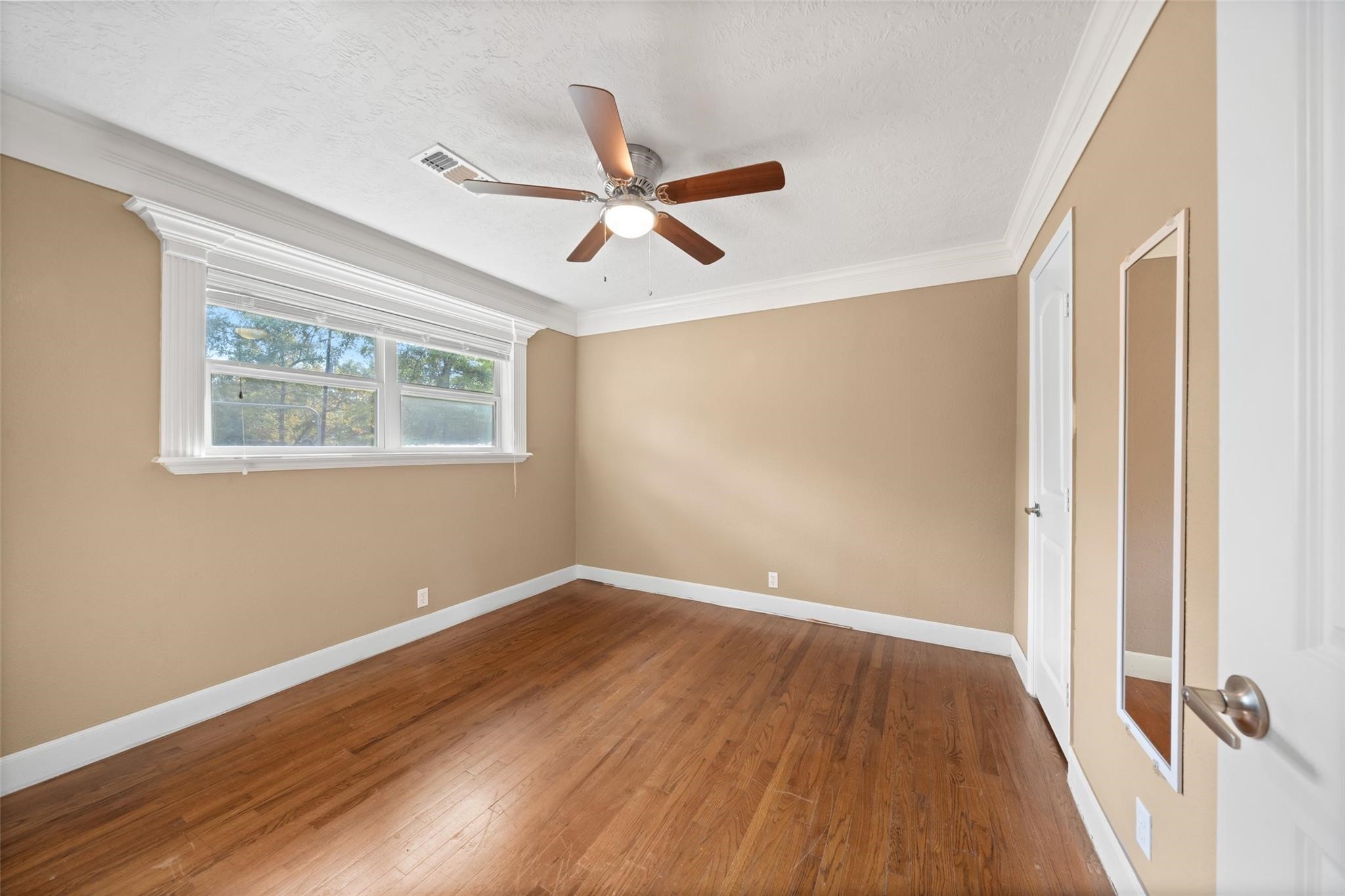 6742 Dusty Lane Conroe, TX 77306 - Photo 18 of 33 Bedroom 2 with ceiling fan.