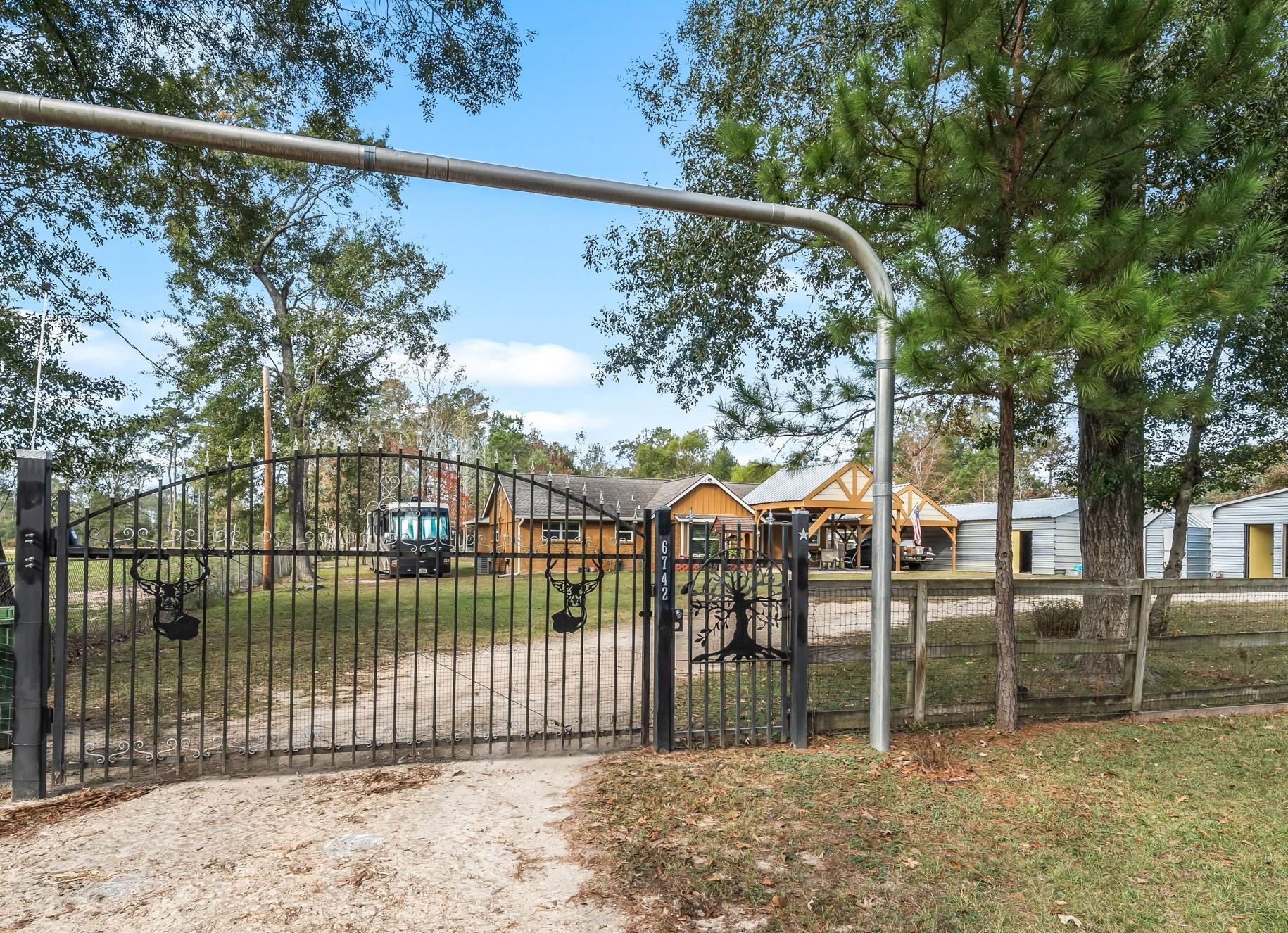 6742 Dusty Lane Conroe, TX 77306 - Photo 2 of 33 Electric gate at front entrance for added security and privacy comes with 4 remote controls.
