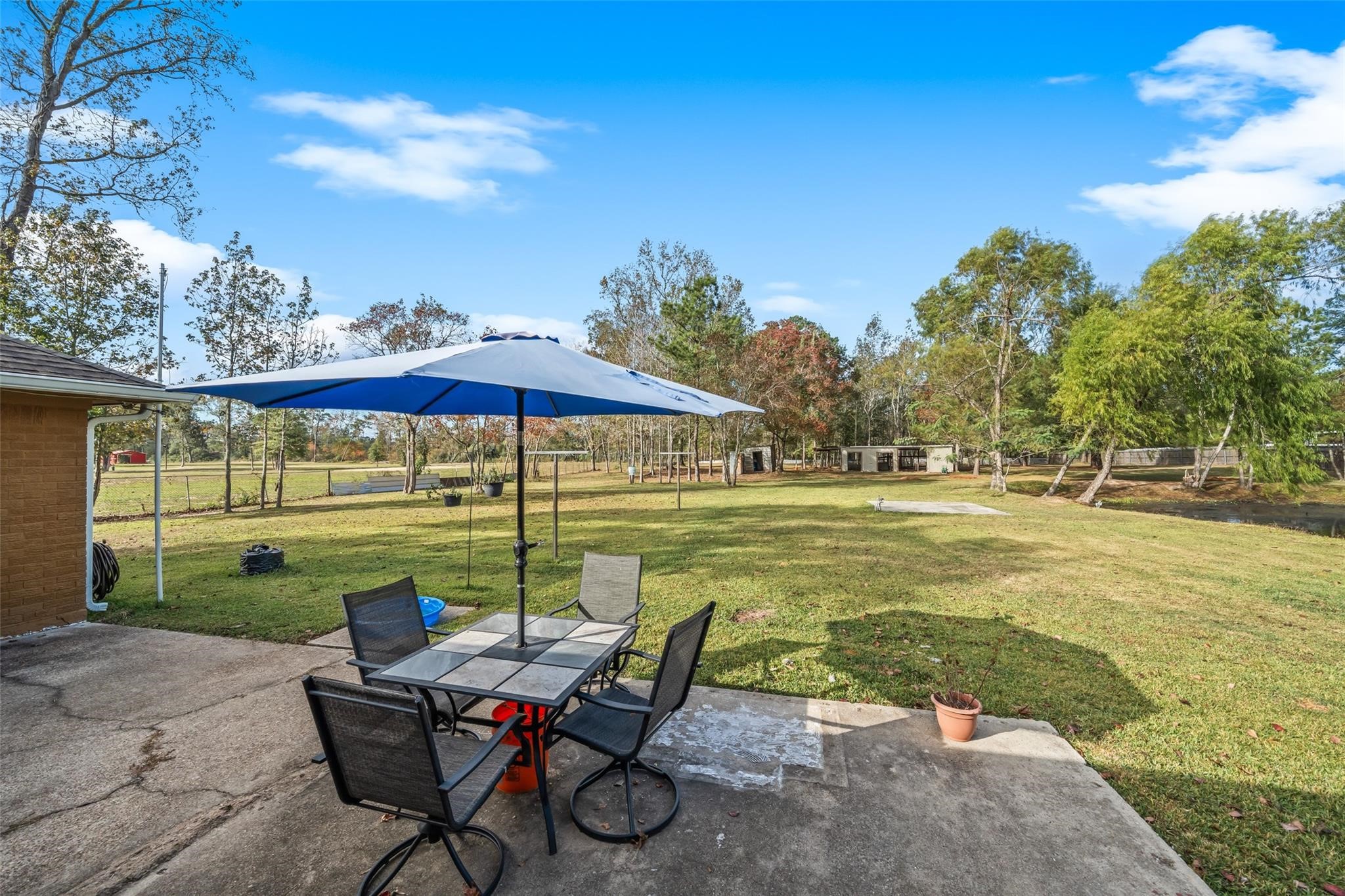 6742 Dusty Lane Conroe, TX 77306 - Photo 26 of 33 Back porch patio offers expansive views of property while enjoying the view of the pond to the right.