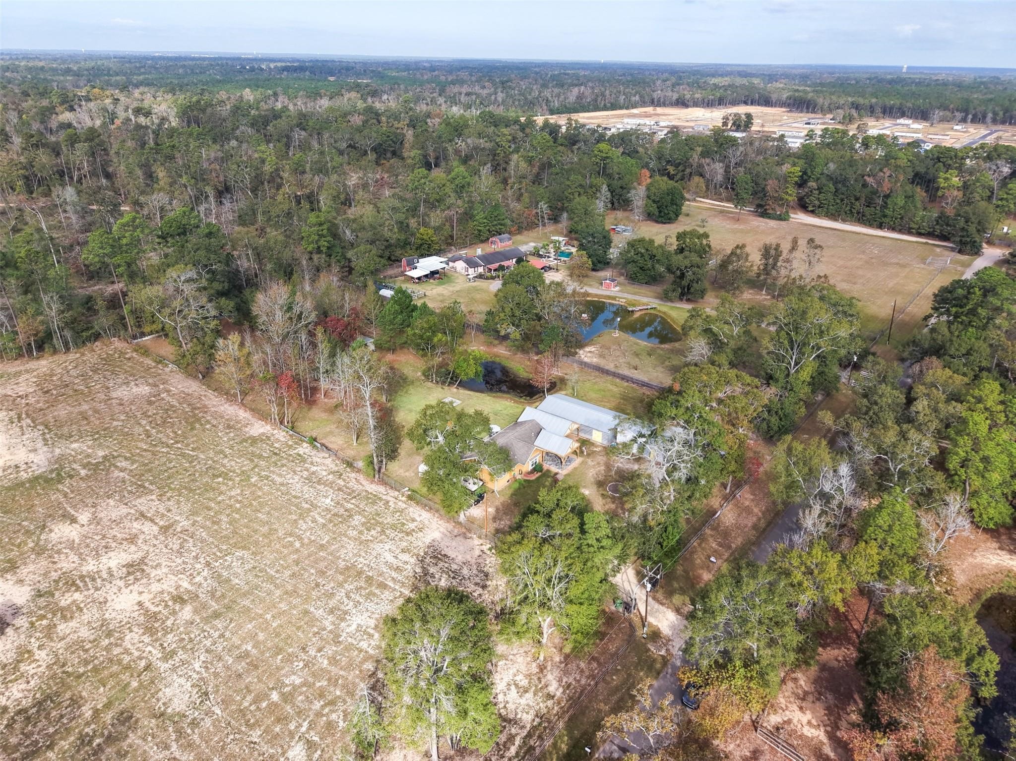 6742 Dusty Lane Conroe, TX 77306 - Photo 32 of 33 Great sky view to show off private road frontage plus a fabulous view of the buildings, pond and space that this property offers.
