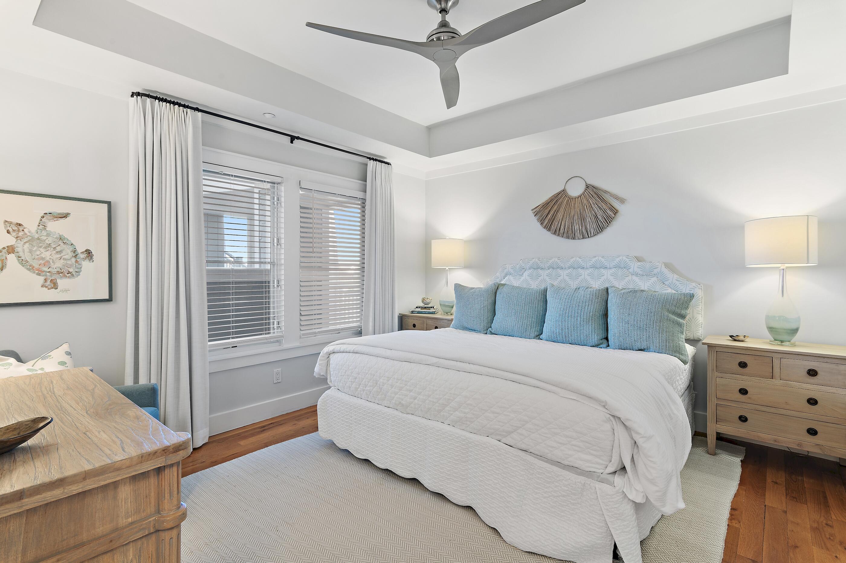 337 Bridge Lane, Unit 312B Watersound, FL 32461 - Photo 15 of 37 a bedroom with a bed and wooden floor