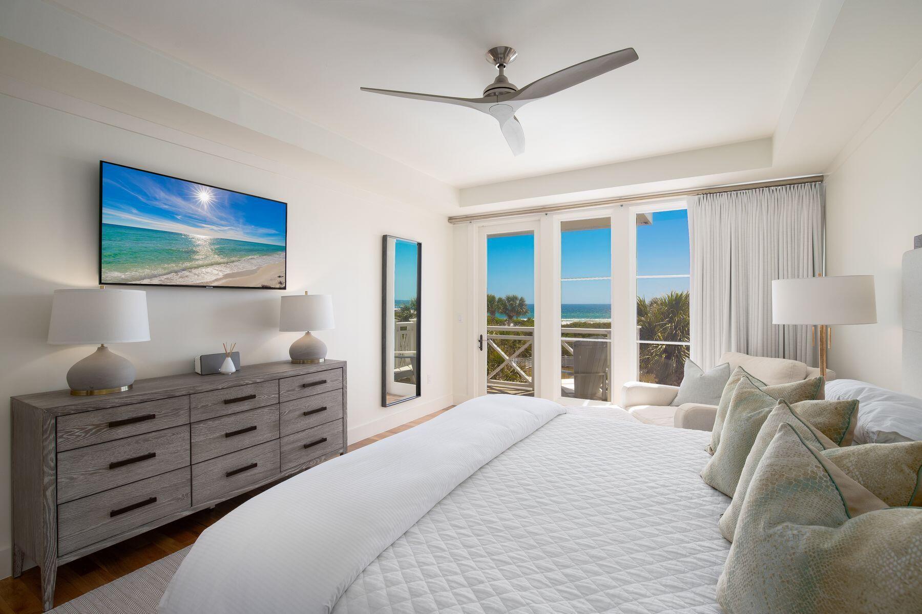 337 Bridge Lane, Unit 312B Watersound, FL 32461 - Photo 10 of 37 a bedroom with a large bed and a flat tv screen
