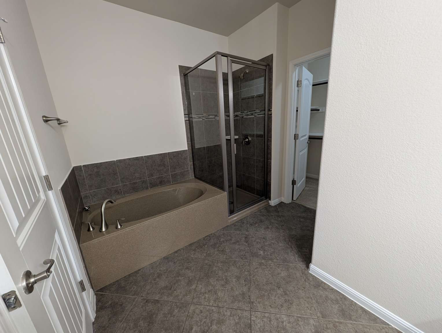 7301 Bandera Ranch Trail, Unit A Austin, TX 78750 - Photo 19 of 20 Modern bath features a deep soaking tub and a sleek glass-enclosed shower.