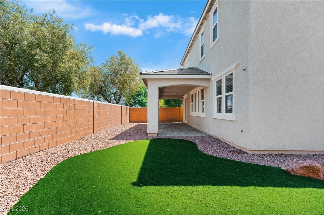 312 Pocono Ranch Avenue North Las Vegas, NV 89031 - Photo 32 of 34 View of yard featuring a fenced backyard and a patio area
