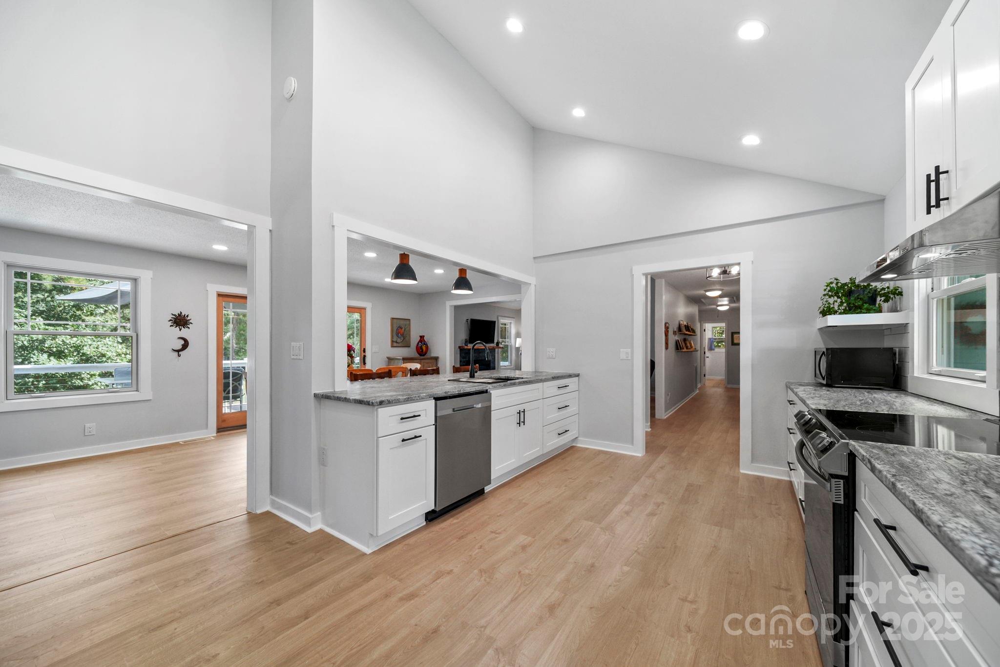 1215 Molokai Drive Fort Mill, SC 29708 - Photo 7 of 25 a large kitchen with stainless steel appliances kitchen island granite countertop a large counter top and a stove top oven