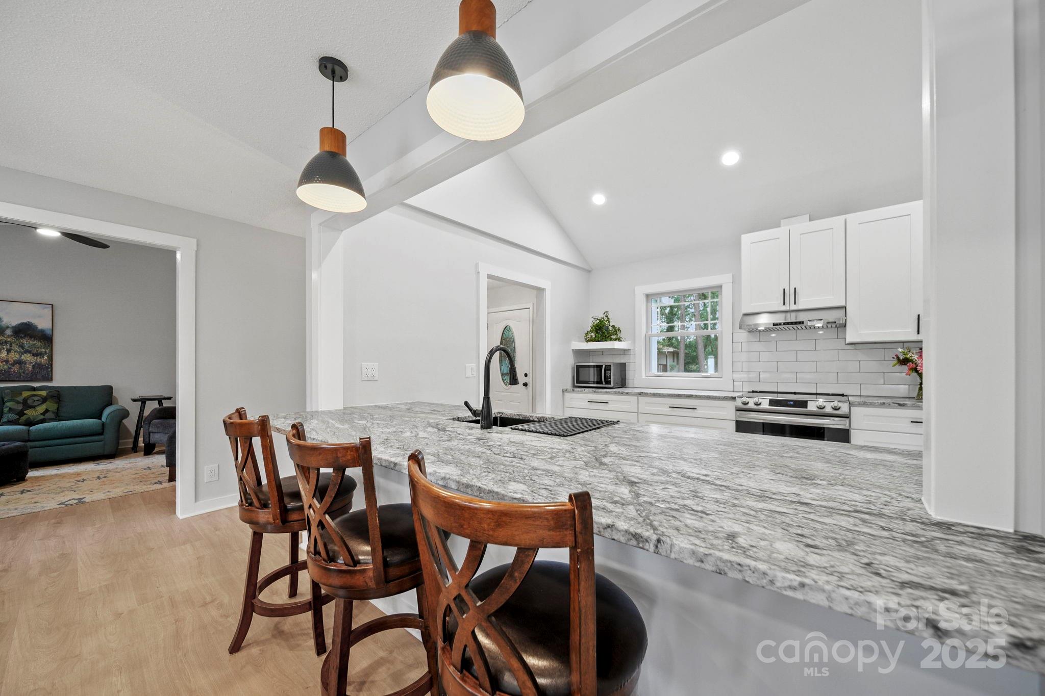 1215 Molokai Drive Fort Mill, SC 29708 - Photo 9 of 25 a kitchen with a table chairs stove and cabinets
