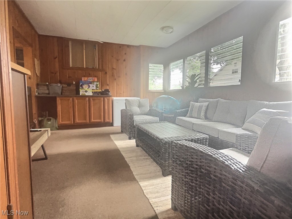 3688 Easton Road Norton, OH 44203 - Photo 25 of 37 Living room with wood walls and light colored carpet