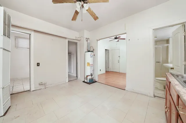 a view of empty room with cabinet and ceiling fan