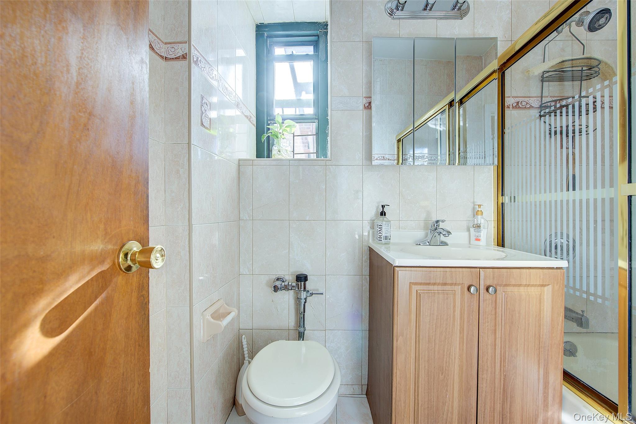 78-11 35th Avenue, Unit 4D Queens, NY 11372 - Photo 11 of 12 a bathroom with a granite countertop sink toilet and shower