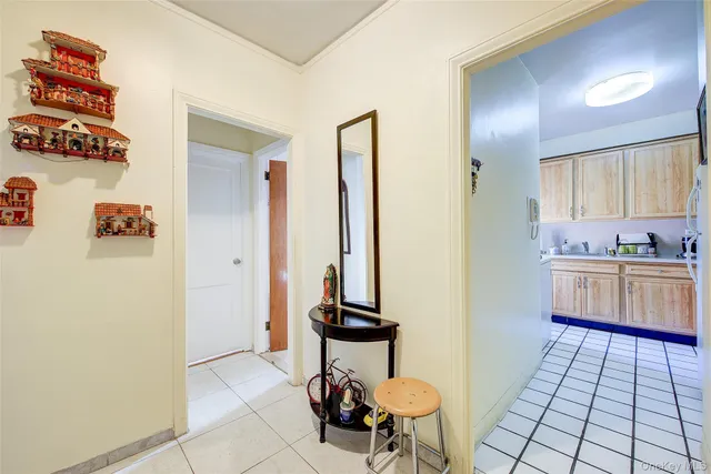 a room with granite countertop white cabinets and stainless steel appliances