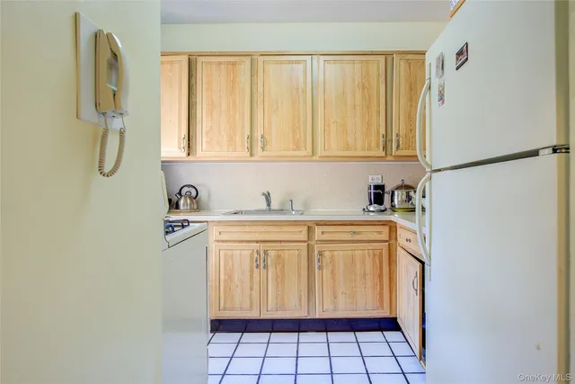 a kitchen with stainless steel appliances granite countertop a sink and a white cabinets