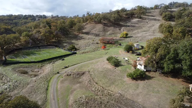 an aerial view of a house with a yard