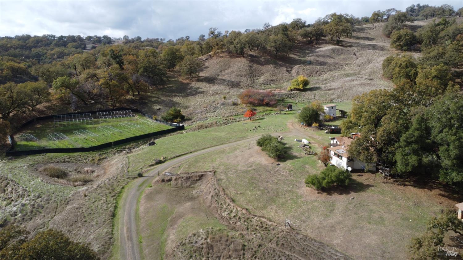 an aerial view of a house with a yard