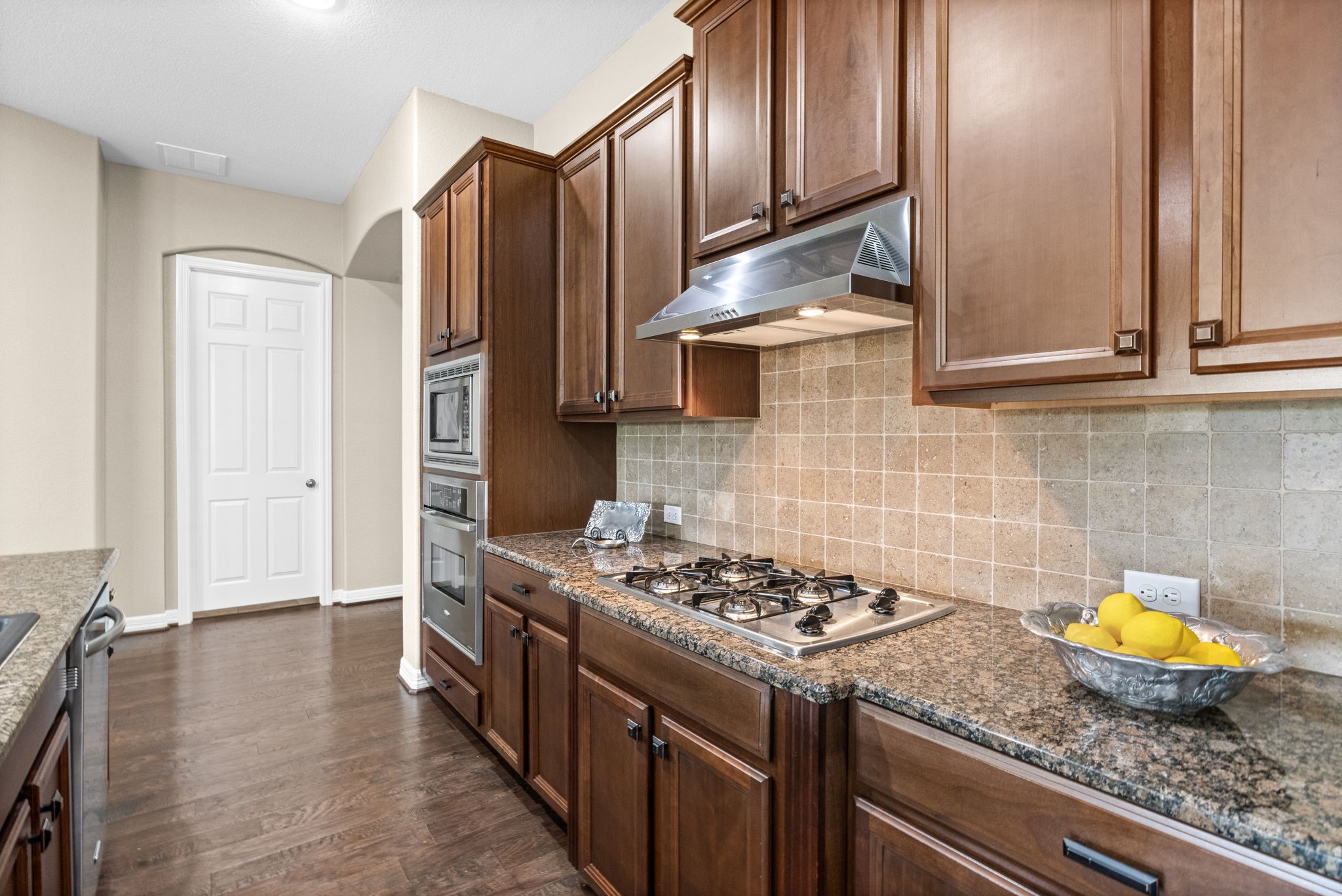 27642 Linden Ridge Lane Fulshear, TX 77441 - Photo 8 of 42 The gorgeous granite countertops, 4x4 tile backsplash, and oil-rubbed bronze hardware blend beautifully together, creating a warm and cohesive design that complements the overall style of the Kitchen.