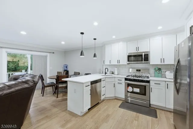 a kitchen with cabinets a sink dishwasher a stove and a refrigerator