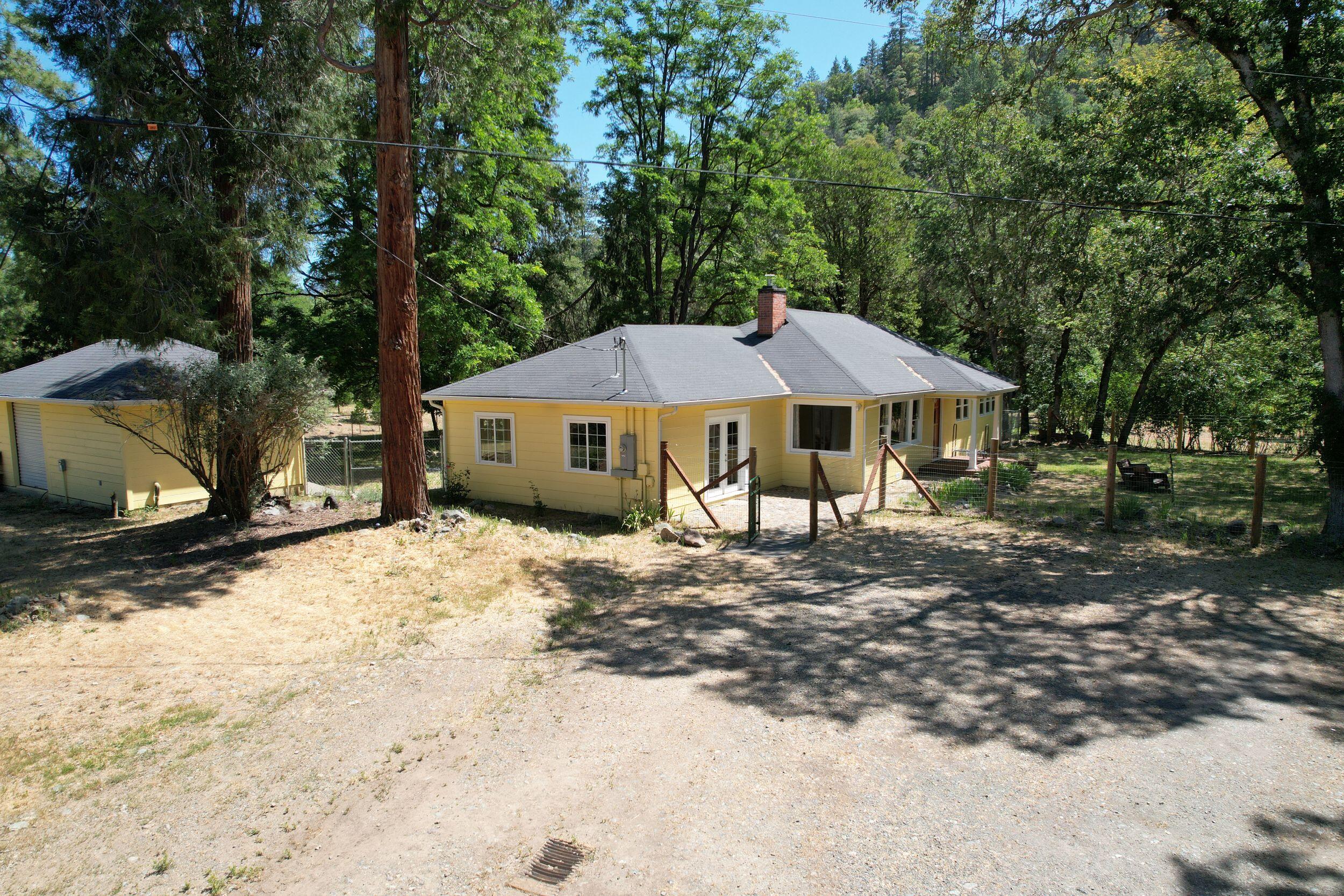 199 Powell Creek Road Williams, OR 97544 - Photo 1 of 57 a front view of a house with garden