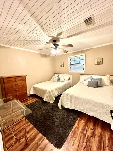 a bedroom with two beds and a dresser