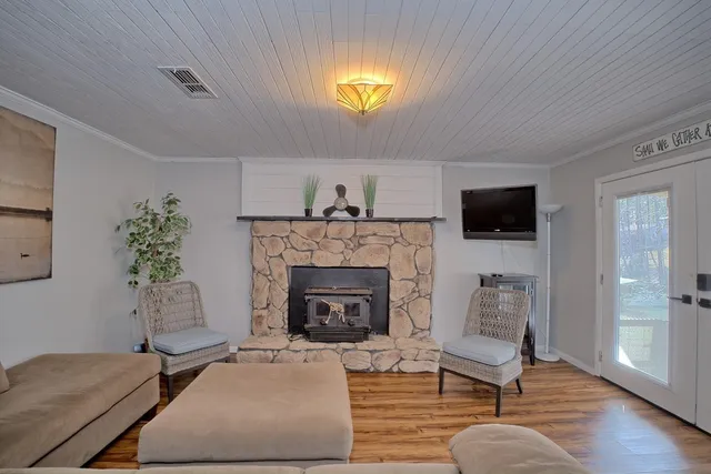 a living room with furniture a fireplace and a flat screen tv