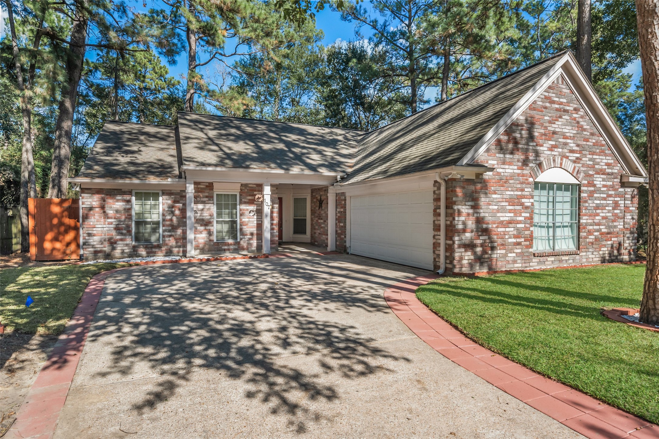107 Sandpebble Drive The Woodlands, TX 77381 - Photo 1 of 30 a view of a house with a yard