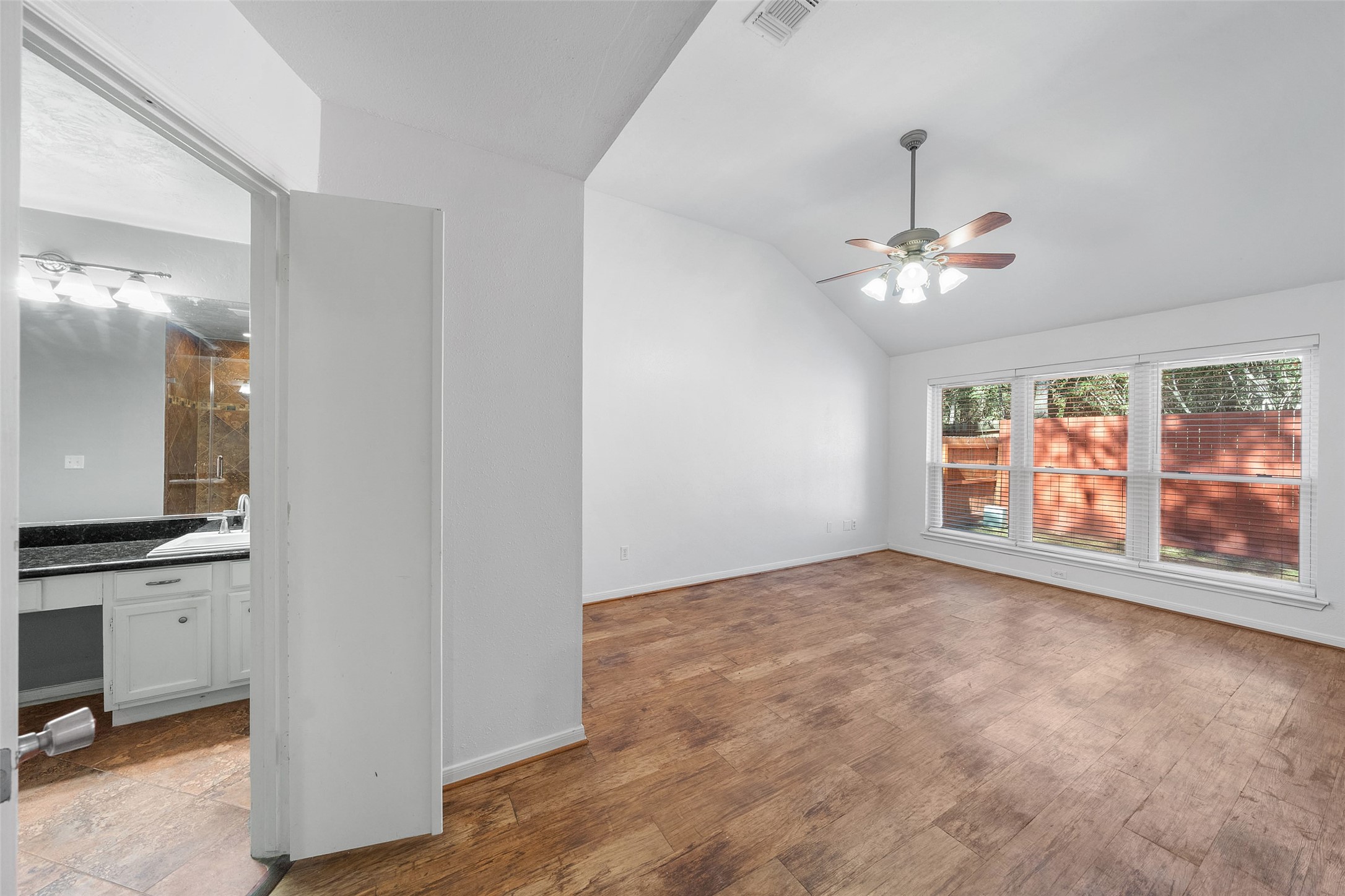 107 Sandpebble Drive The Woodlands, TX 77381 - Photo 12 of 30 a view of an empty room with a window