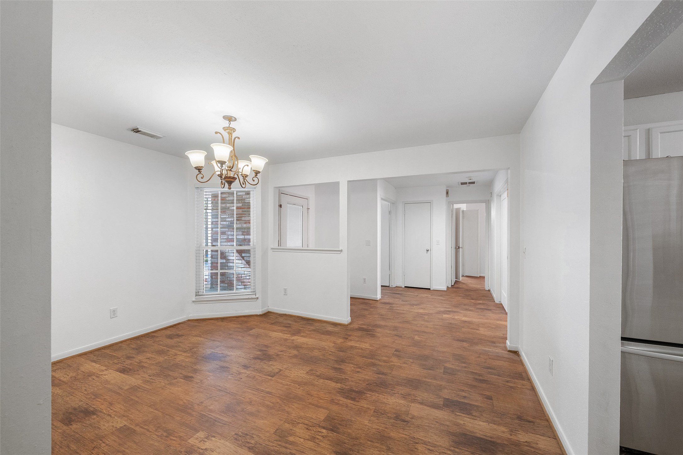 107 Sandpebble Drive The Woodlands, TX 77381 - Photo 19 of 30 wooden floor in an empty room with a window