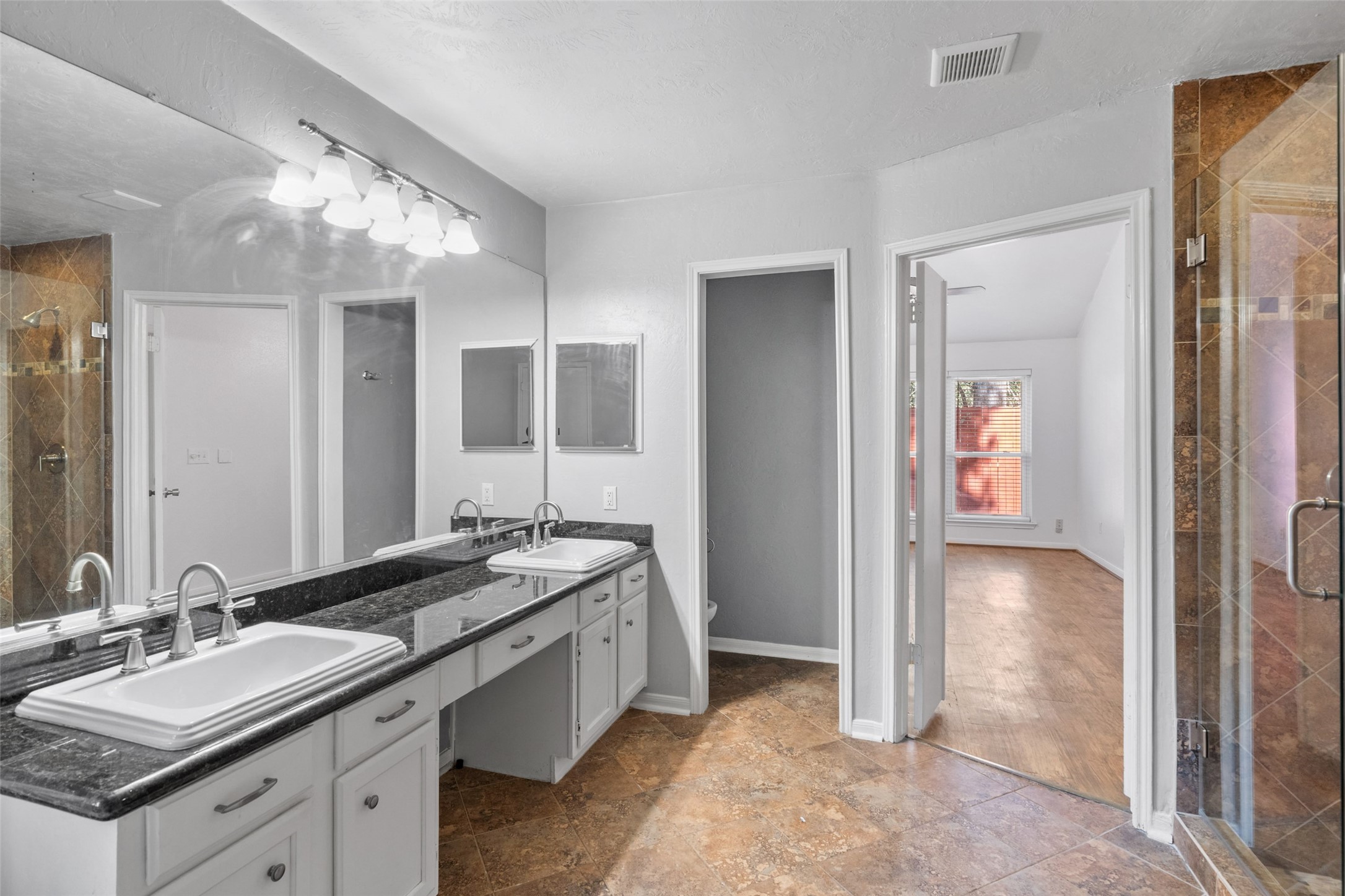 107 Sandpebble Drive The Woodlands, TX 77381 - Photo 24 of 30 a bathroom with a sink and a mirror