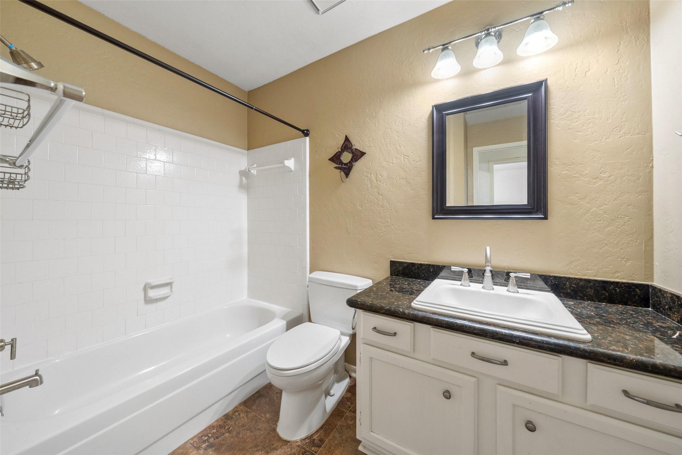107 Sandpebble Drive The Woodlands, TX 77381 - Photo 28 of 30 a bathroom with a toilet a sink a mirror a bathtub and vanity