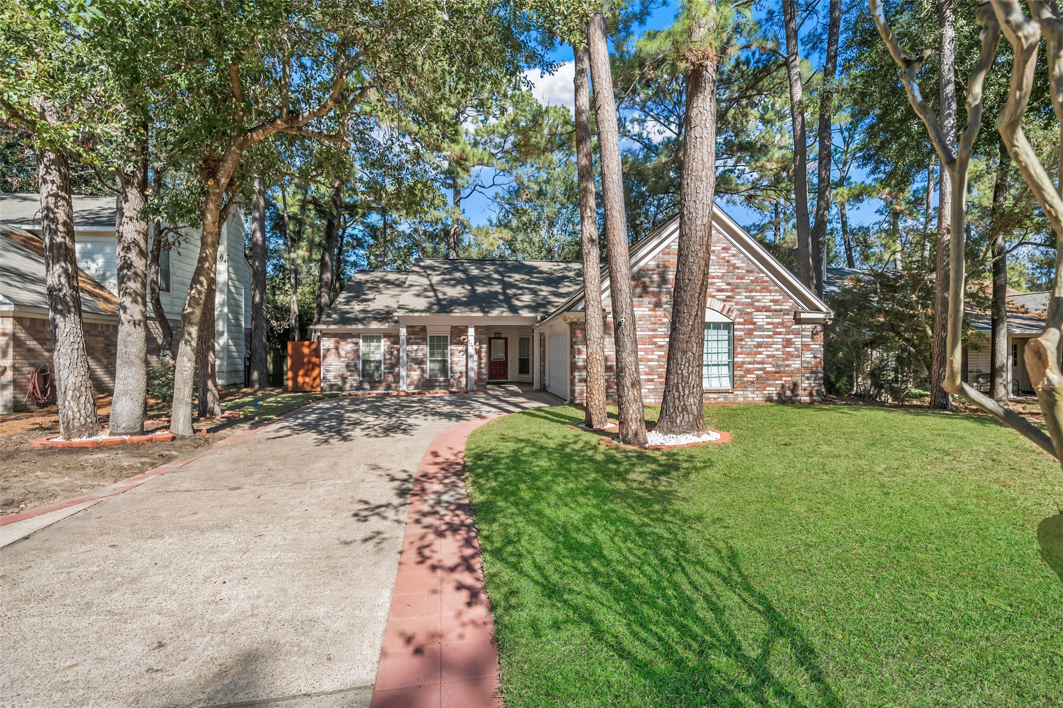 107 Sandpebble Drive The Woodlands, TX 77381 - Photo 3 of 30 a view of a house with backyard and sitting area