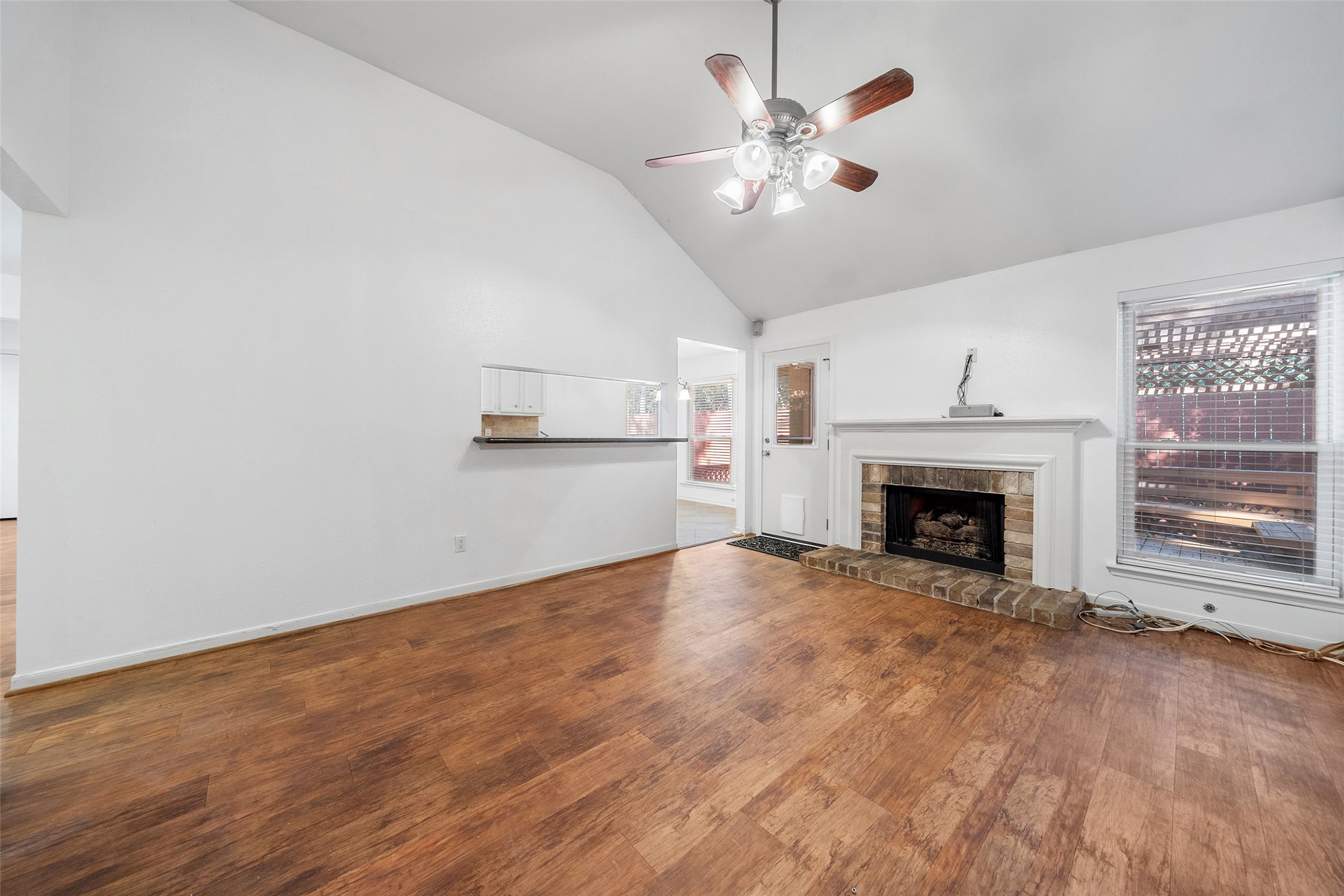 107 Sandpebble Drive The Woodlands, TX 77381 - Photo 6 of 30 a view of empty room with fireplace and wooden floor