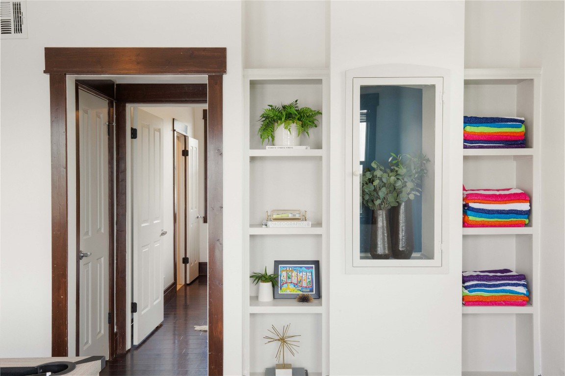 11209 Southwest Oaks Austin, TX 78737 - Photo 15 of 34 Hallway featuring built in shelves and dark wood-type flooring