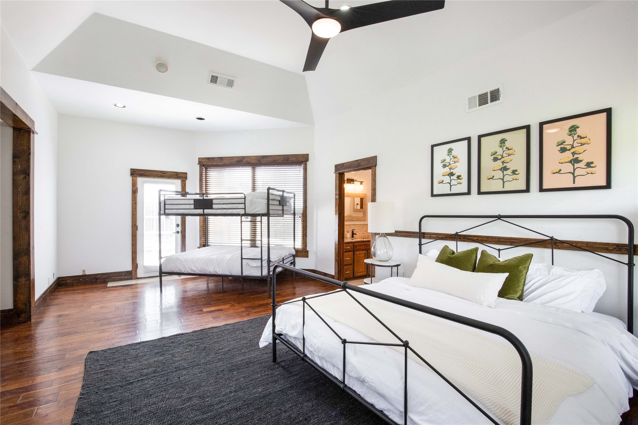 11209 Southwest Oaks Austin, TX 78737 - Photo 24 of 34 Bedroom featuring dark wood-type flooring, connected bathroom, ceiling fan, and lofted ceiling