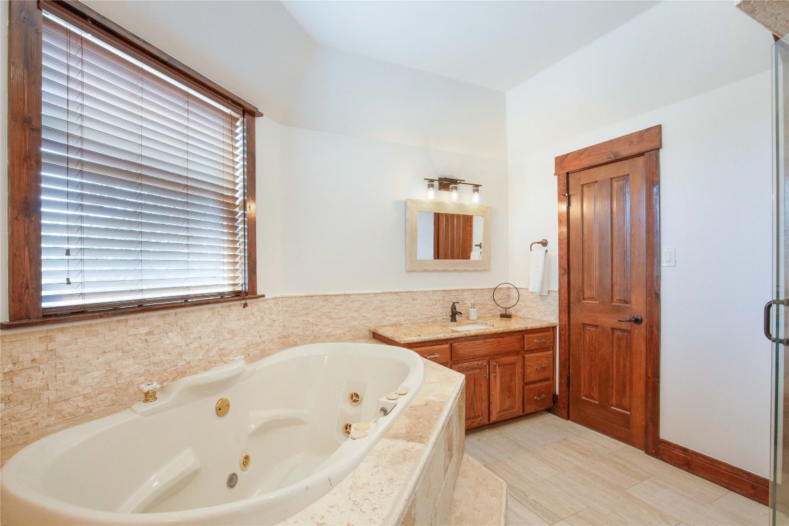 11209 Southwest Oaks Austin, TX 78737 - Photo 25 of 34 Bathroom featuring vanity and a jetted tub