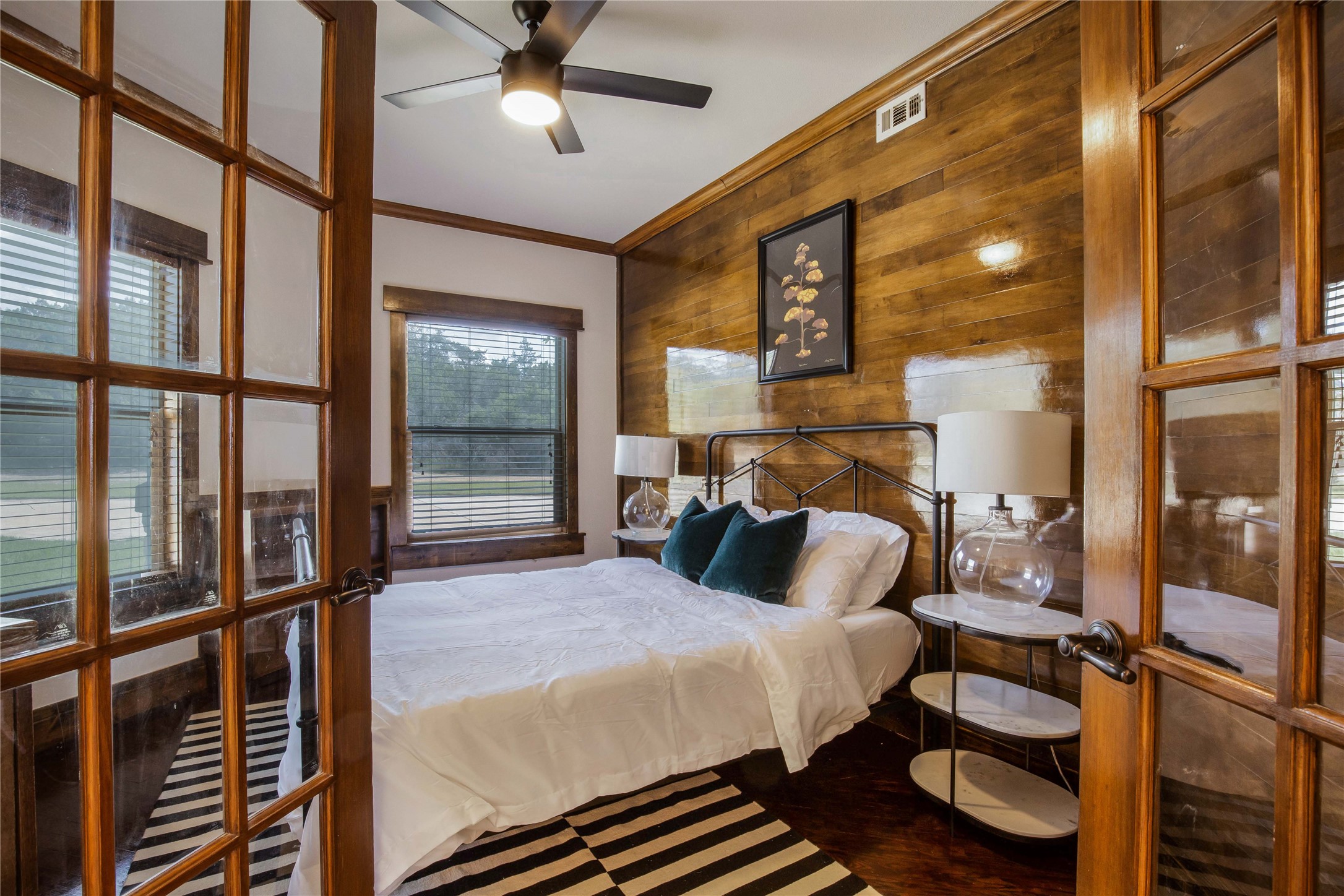 11209 Southwest Oaks Austin, TX 78737 - Photo 33 of 34 Bedroom featuring ornamental molding, wooden walls, and ceiling fan