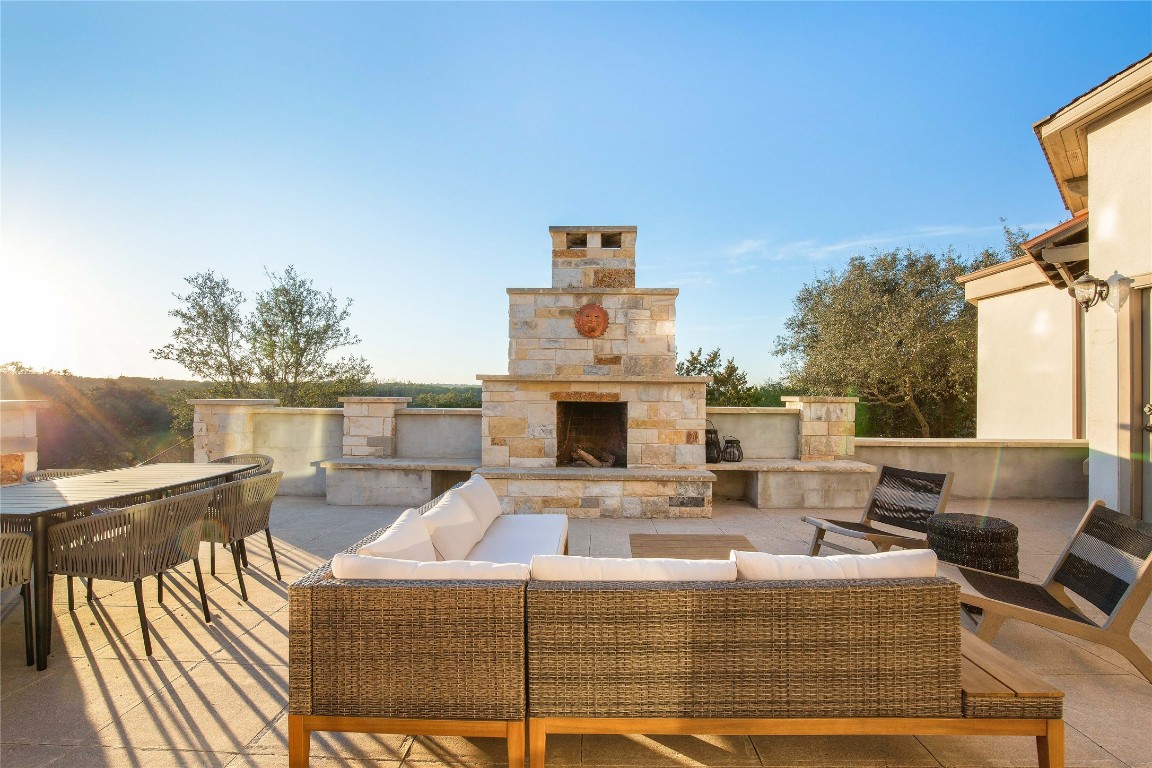 11209 Southwest Oaks Austin, TX 78737 - Photo 6 of 34 View of patio featuring outdoor dining space and an outdoor living space with a fireplace