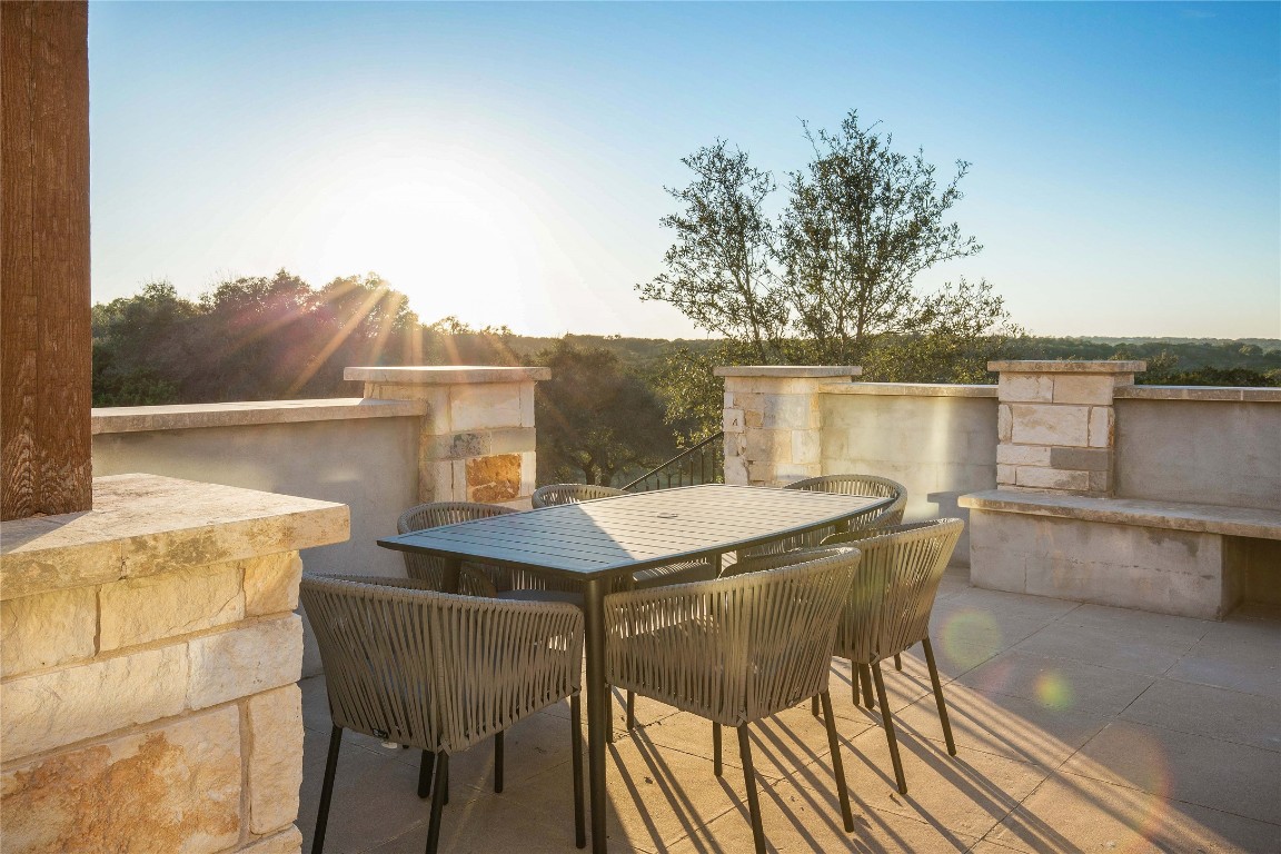 11209 Southwest Oaks Austin, TX 78737 - Photo 7 of 34 Patio terrace at dusk featuring outdoor dining space and a patio
