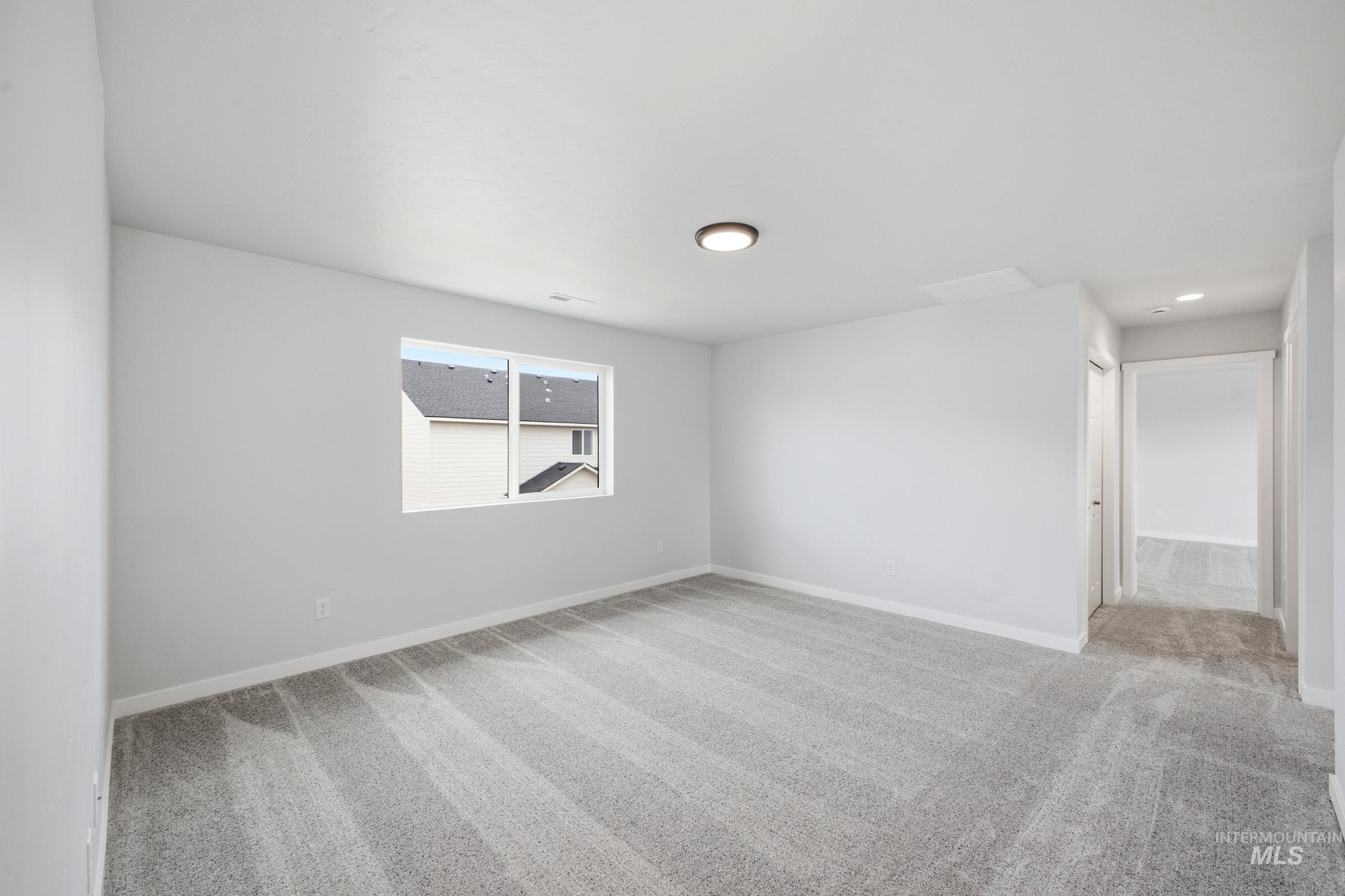 13718 Inman Court Caldwell, ID 83607 - Photo 12 of 20 Unfurnished room featuring light carpet and baseboards