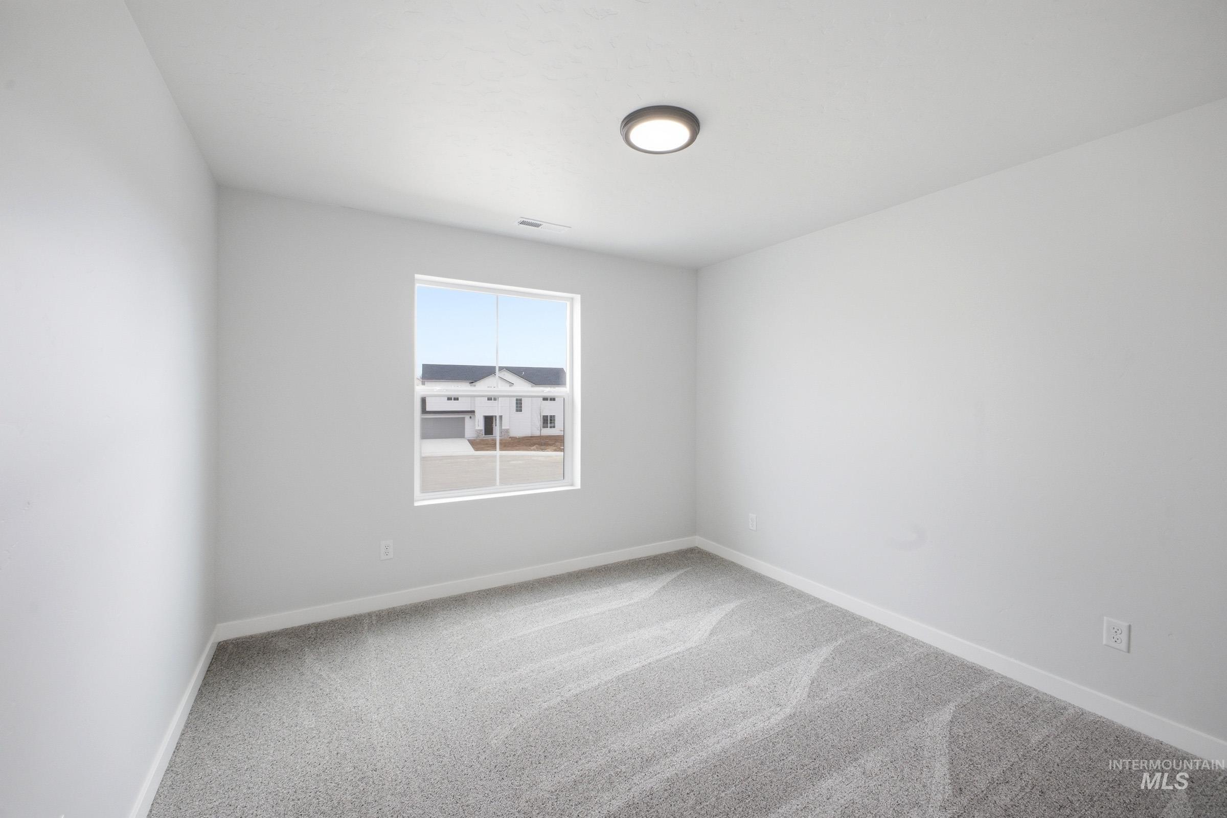 13718 Inman Court Caldwell, ID 83607 - Photo 13 of 20 Unfurnished room with light carpet and baseboards