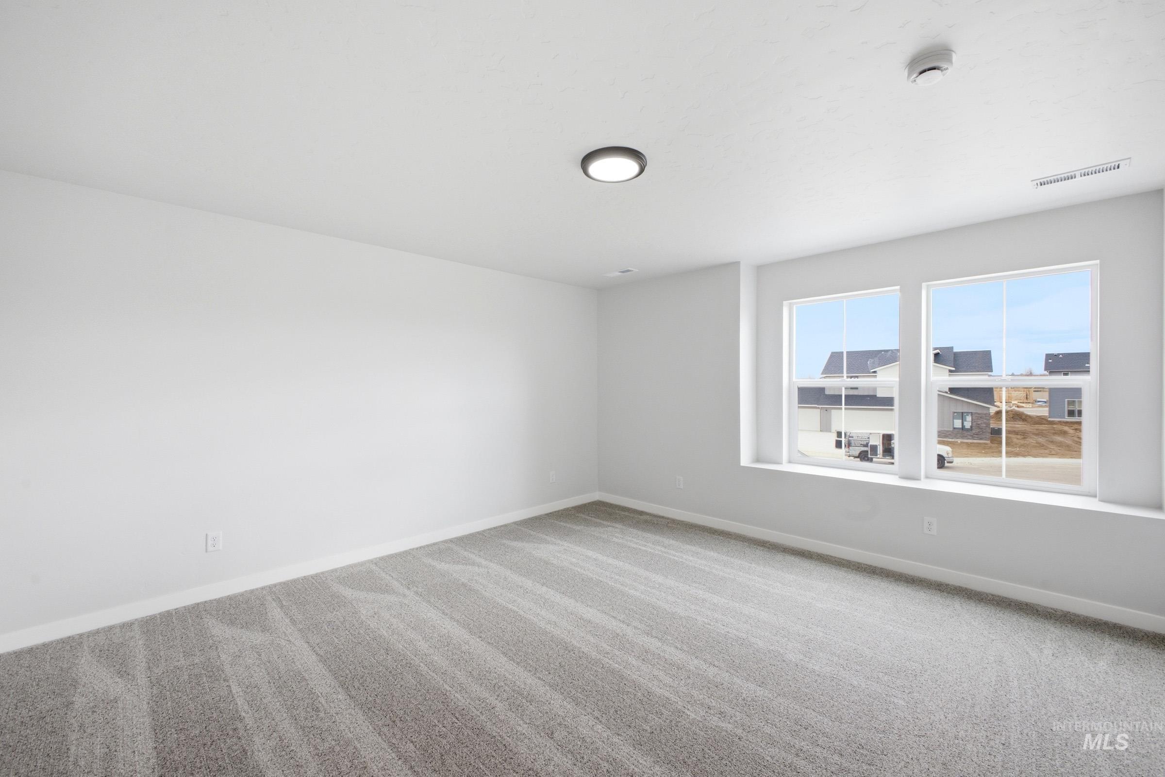 13718 Inman Court Caldwell, ID 83607 - Photo 17 of 20 Empty room featuring light colored carpet and baseboards