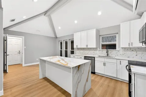 a kitchen with a stove a sink and a refrigerator