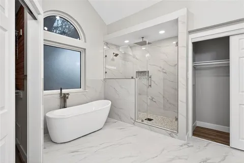 a bathroom with a tub and a shower
