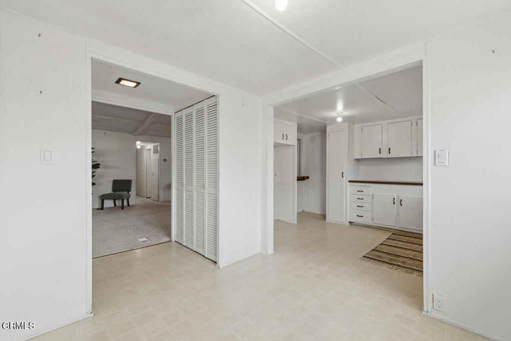 1225 South Rice Road, Unit 41 Ojai, CA 93023 - Photo 13 of 38 a view of a kitchen with white cabinets and wooden floor
