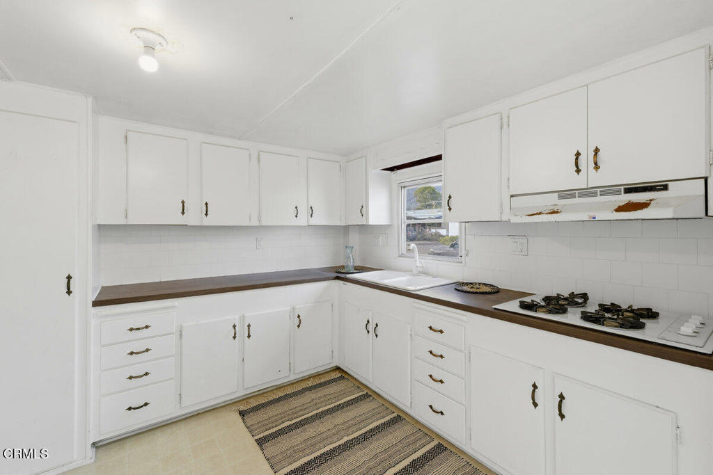1225 South Rice Road, Unit 41 Ojai, CA 93023 - Photo 7 of 38 a kitchen with granite countertop white cabinets and sink