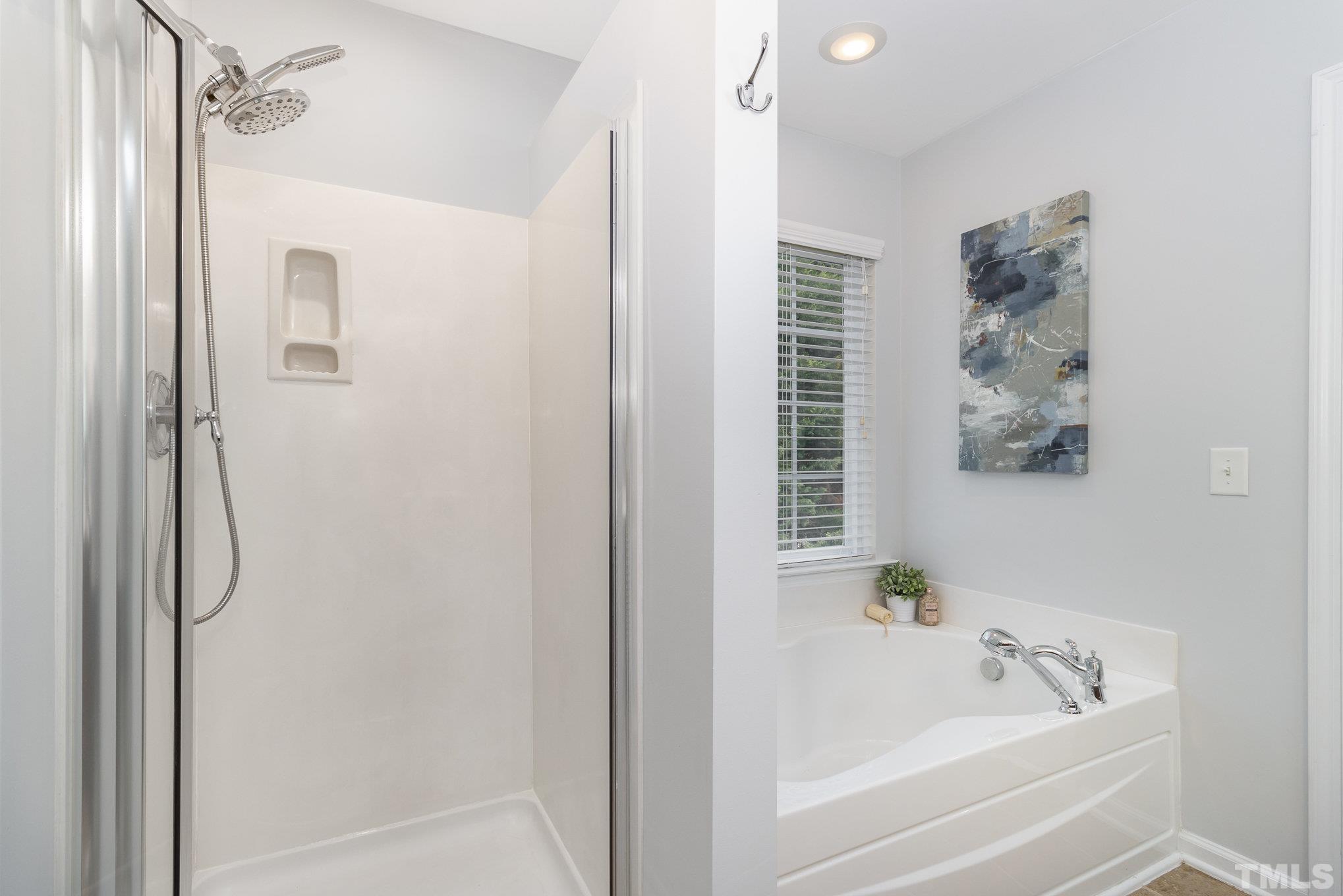 8220 Pilots View Drive Raleigh, NC 27617 - Photo 13 of 20 a bathroom with a bathtub a shower and a sink