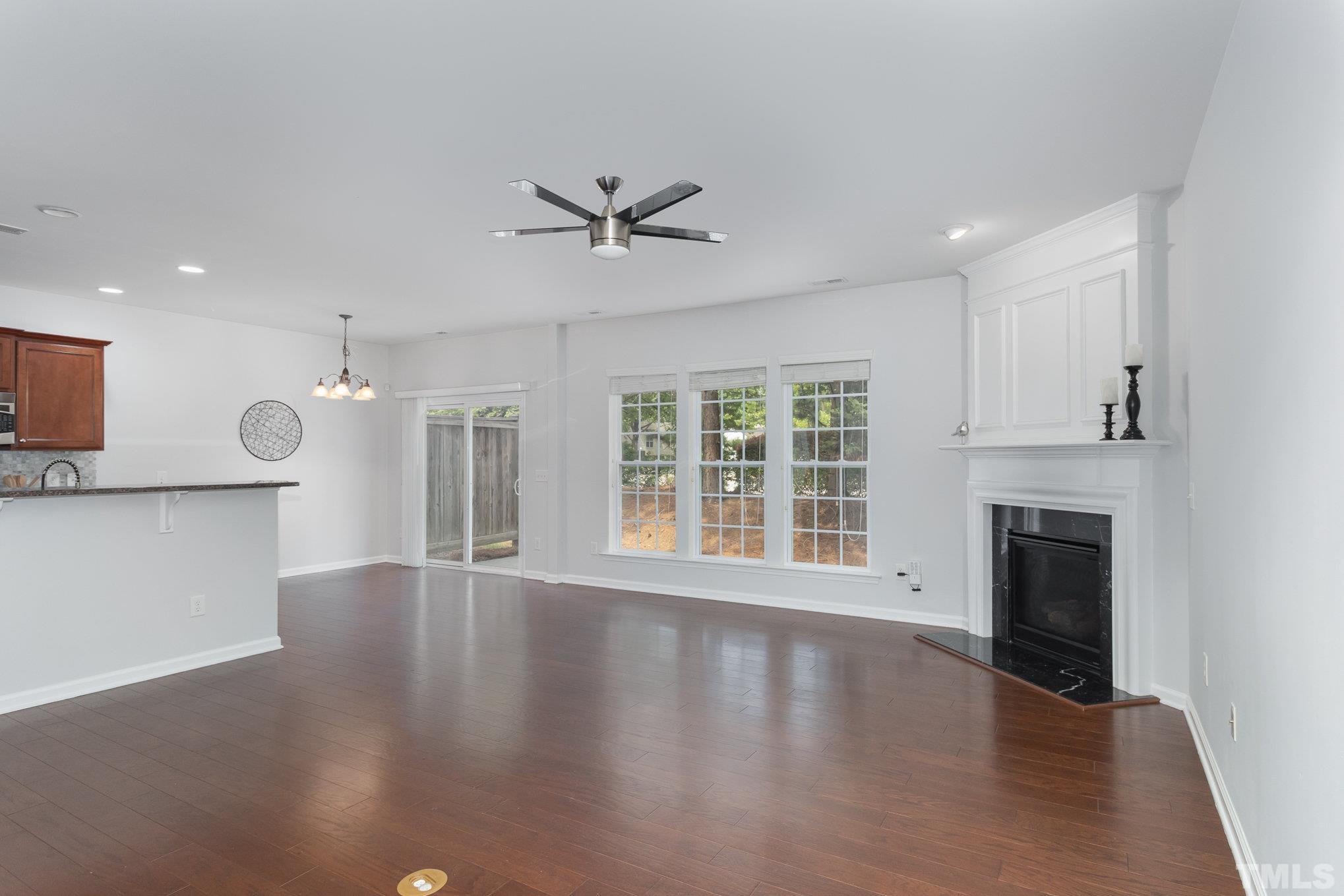 8220 Pilots View Drive Raleigh, NC 27617 - Photo 3 of 20 a view of an empty room with a fireplace and a window