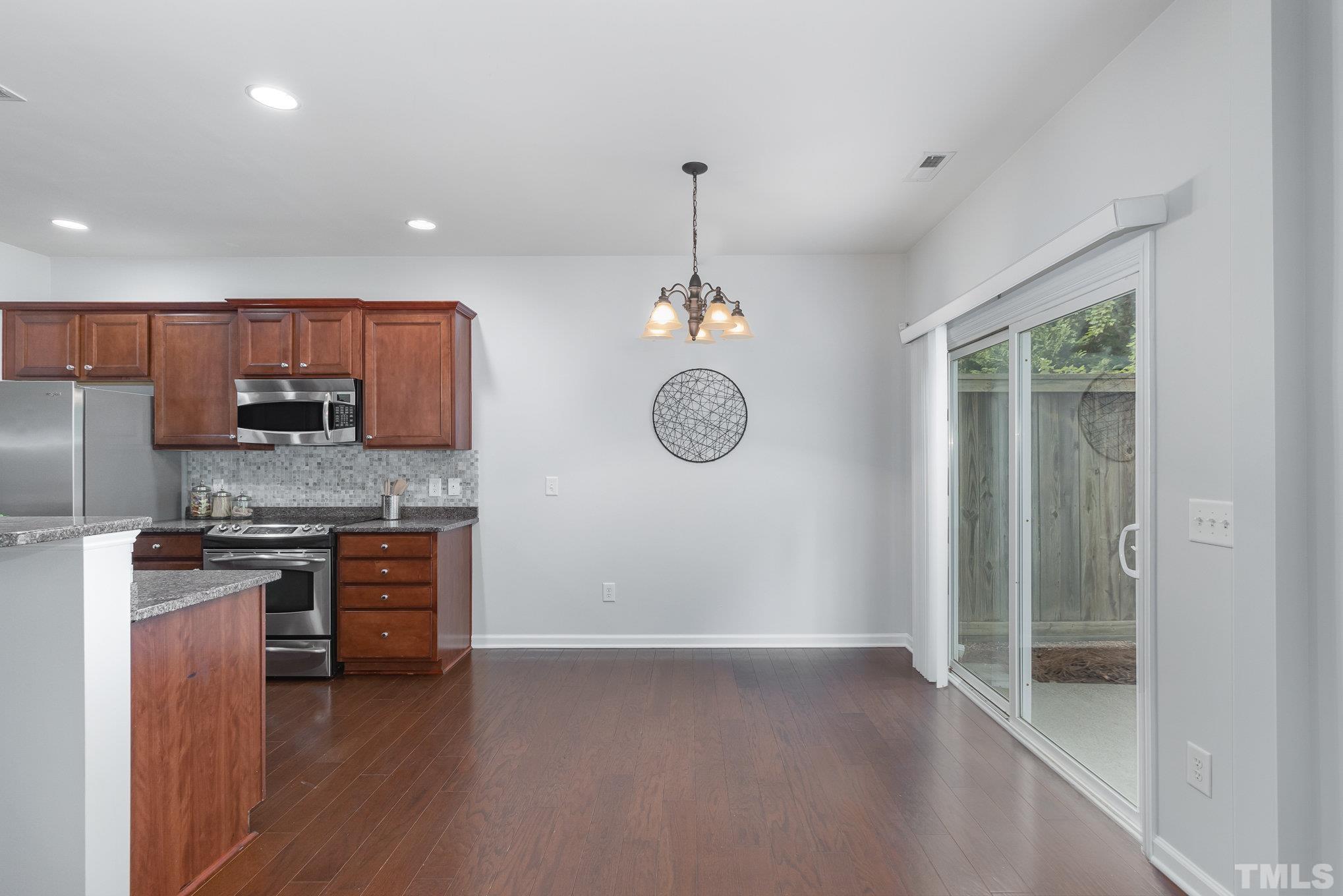 8220 Pilots View Drive Raleigh, NC 27617 - Photo 5 of 20 a kitchen with stainless steel appliances granite countertop a stove a sink and a refrigerator