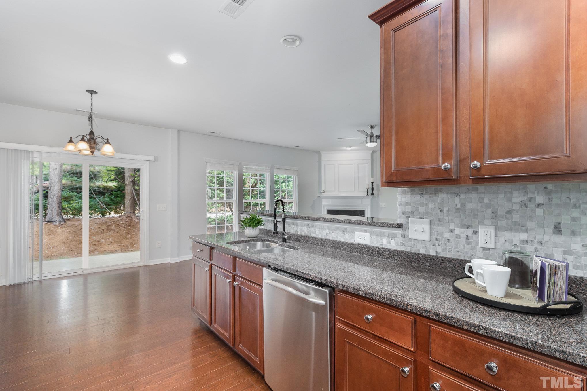 8220 Pilots View Drive Raleigh, NC 27617 - Photo 8 of 20 a kitchen with stainless steel appliances granite countertop wooden cabinets a sink and dishwasher