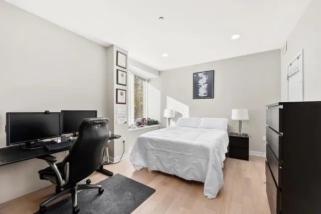 a bedroom with a bed and a desk